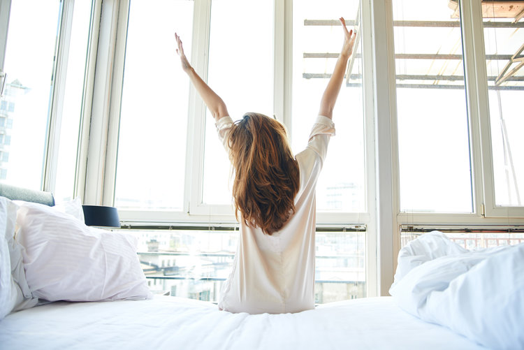 Woman stretching in bed